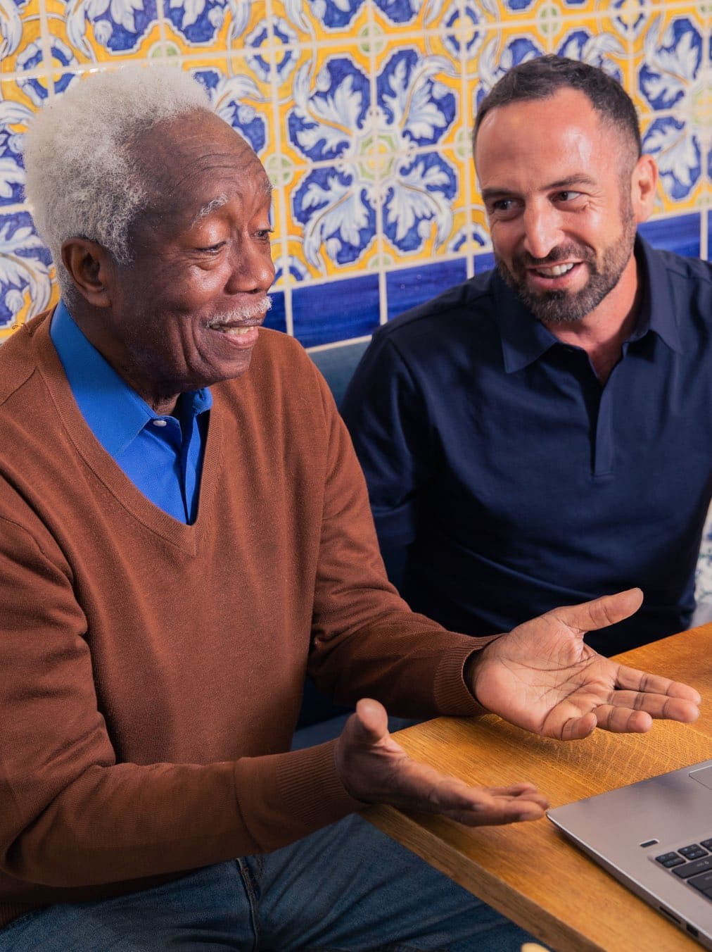 Caregiver sitting at the kitchen table with elderly man