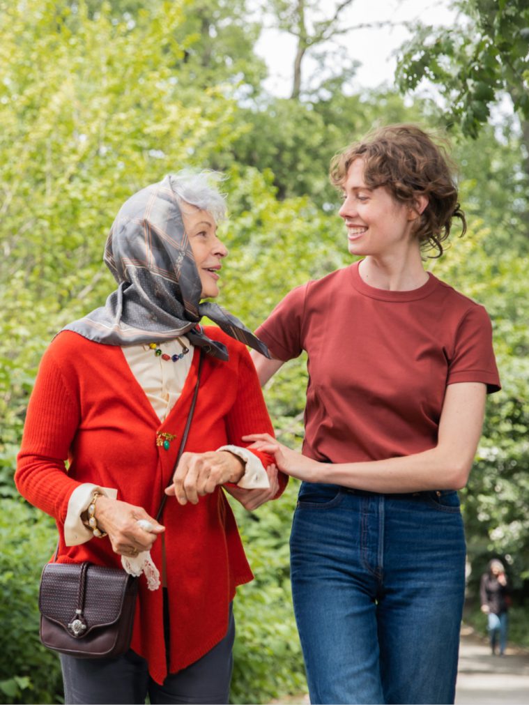 Older woman with memory loss being supported by a caregiver