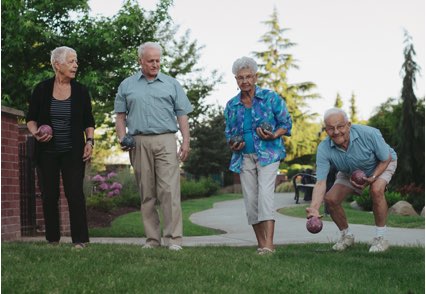 Four seniors play bocce ball