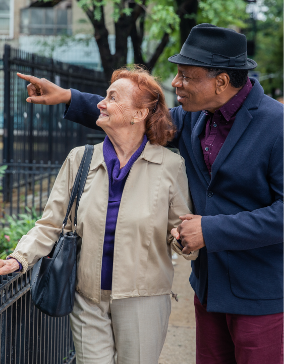 Companion walking with elderly adult in New York City